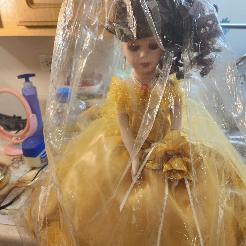 Beautiful wedding collectible doll with gold dress